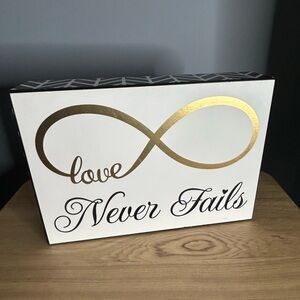 Hobby Lobby Gold and Black Love Never Fails Sign